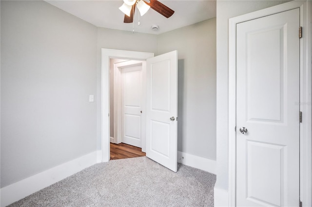 unfurnished bedroom featuring carpet flooring, baseboards, and a ceiling fan
