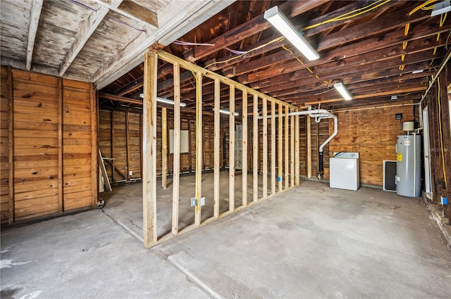 unfinished below grade area with water heater and washer / dryer