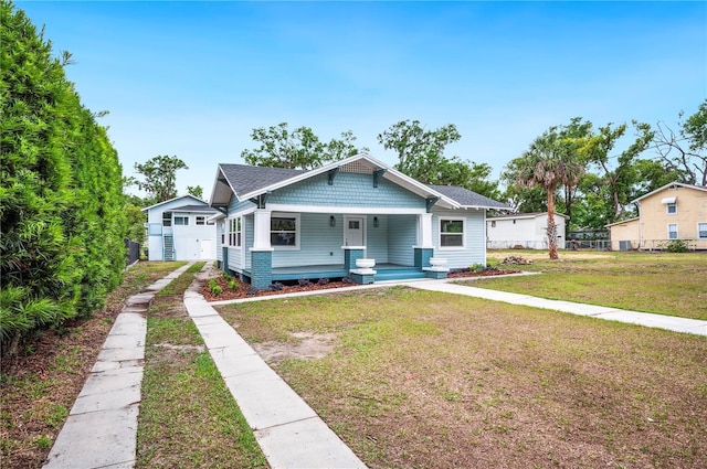 bungalow with covered porch and driveway
