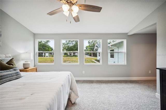 carpeted bedroom with baseboards and ceiling fan