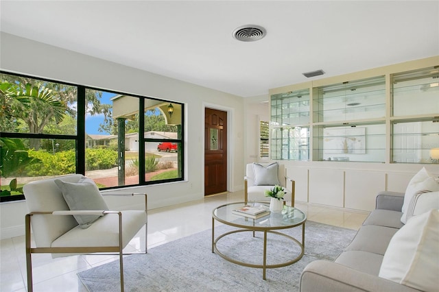 living room featuring light tile patterned floors and baseboards