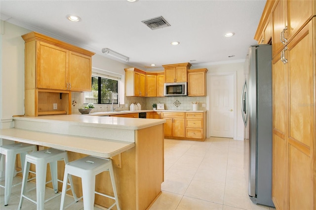 kitchen with stainless steel appliances, a peninsula, crown molding, tasteful backsplash, and light countertops