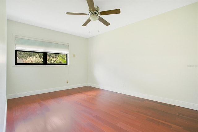 unfurnished room featuring wood finished floors, baseboards, and a ceiling fan