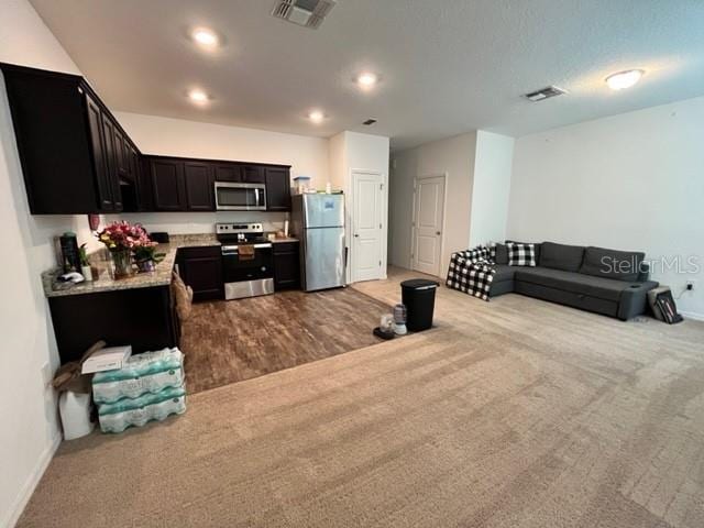 879 Grandin St, Davenport, FL 33837 - kitchen featuring appliances with stainless steel finishes, carpet, open floor plan, light countertops, and recessed lighting