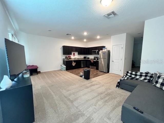 879 Grandin St, Davenport, FL 33837 - living area featuring light colored carpet, recessed lighting, and baseboards