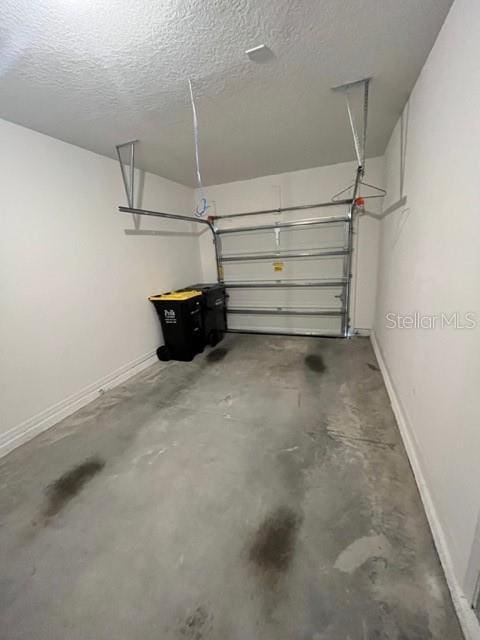 879 Grandin St, Davenport, FL 33837 - garage featuring baseboards