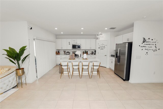 2039 Rosewood Cir, Lakeland, FL 33810 - kitchen featuring stainless steel appliances, a breakfast bar area, white cabinetry, recessed lighting, and light countertops
