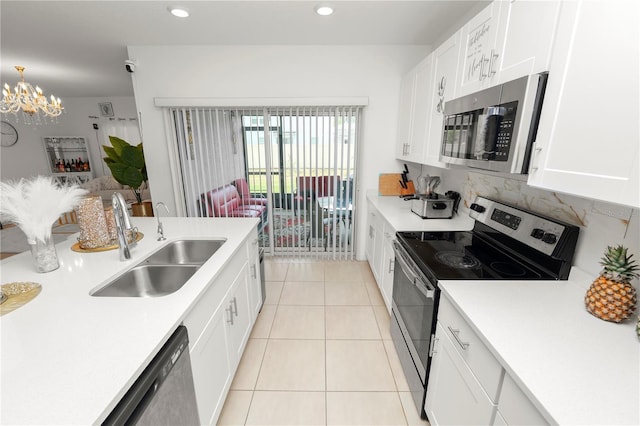 2039 Rosewood Cir, Lakeland, FL 33810 - kitchen featuring appliances with stainless steel finishes, a sink, light countertops, white cabinetry, and recessed lighting