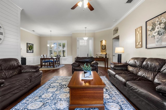 8909 N Campbell Rd, Lakeland, FL 33810 - living room featuring ceiling fan, wood finished floors, a chandelier, crown molding, and a wainscoted wall