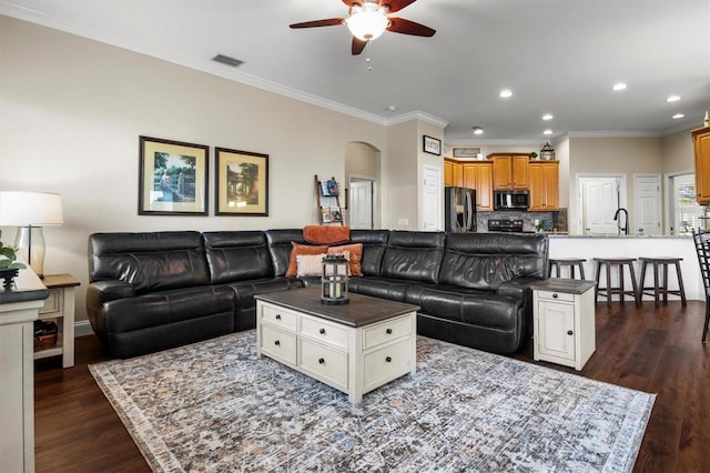 8909 N Campbell Rd, Lakeland, FL 33810 - living area with a ceiling fan, arched walkways, dark wood-style floors, recessed lighting, and ornamental molding
