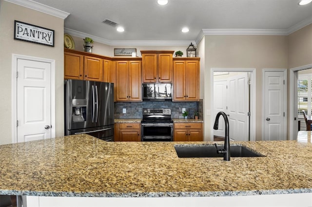 8909 N Campbell Rd, Lakeland, FL 33810 - kitchen with appliances with stainless steel finishes, light stone countertops, brown cabinetry, decorative backsplash, and ornamental molding