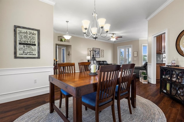 8909 N Campbell Rd, Lakeland, FL 33810 - dining space featuring dark wood-style flooring, a chandelier, crown molding, wainscoting, and ceiling fan