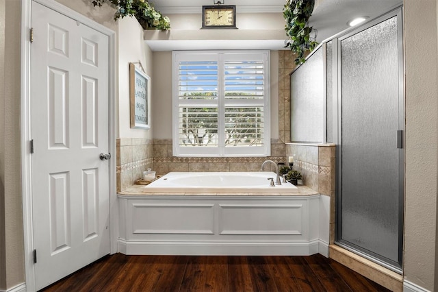 8909 N Campbell Rd, Lakeland, FL 33810 - full bath featuring wood finished floors, a stall shower, and a bath