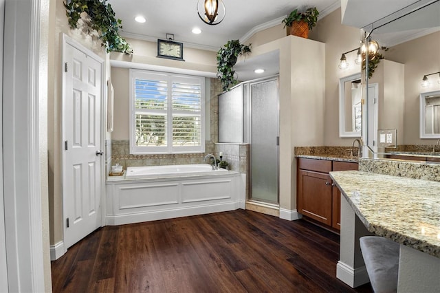 8909 N Campbell Rd, Lakeland, FL 33810 - bathroom featuring a bath, a shower stall, crown molding, wood finished floors, and vanity