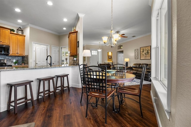 8909 N Campbell Rd, Lakeland, FL 33810 - dining area with dark wood-style flooring, recessed lighting, ornamental molding, ceiling fan, and a chandelier