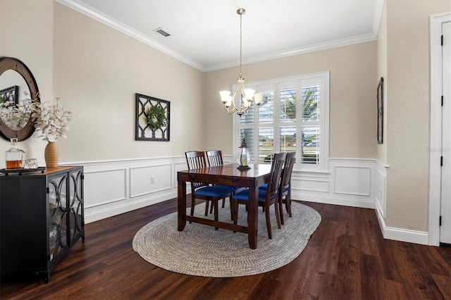 8909 N Campbell Rd, Lakeland, FL 33810 - dining space featuring wood finished floors, a chandelier, ornamental molding, wainscoting, and a decorative wall