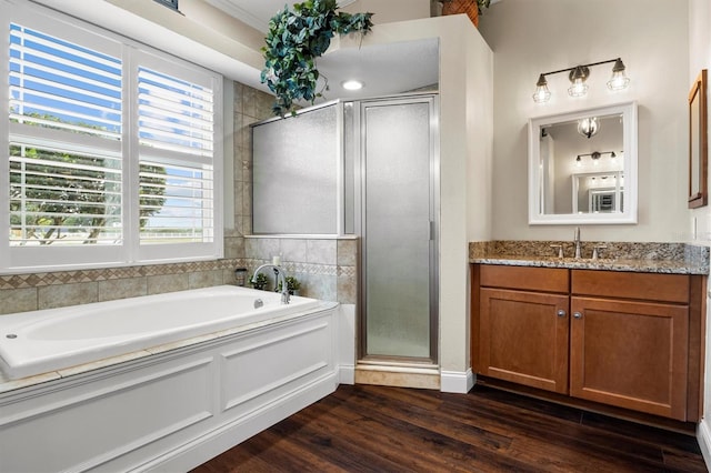 8909 N Campbell Rd, Lakeland, FL 33810 - full bath with vanity, a stall shower, a bath, and wood finished floors