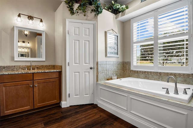 8909 N Campbell Rd, Lakeland, FL 33810 - bathroom with vanity, a bath, and wood finished floors