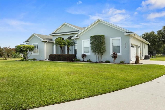 8909 N Campbell Rd, Lakeland, FL 33810 - single story home featuring a garage, a front yard, concrete driveway, and stucco siding