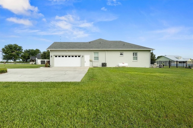 8909 N Campbell Rd, Lakeland, FL 33810 - back of property featuring driveway, a garage, and stucco siding