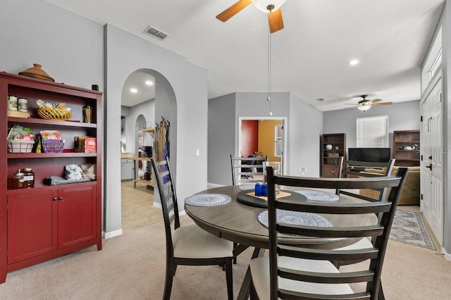 4041 Byrds Crossing Dr, Lakeland, FL 33812 - dining space featuring a ceiling fan, light carpet, arched walkways, baseboards, and recessed lighting