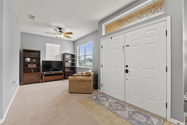 4041 Byrds Crossing Dr, Lakeland, FL 33812 - foyer entrance featuring a ceiling fan, a textured ceiling, carpet, and baseboards