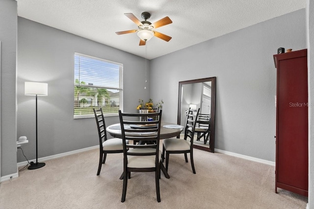 4041 Byrds Crossing Dr, Lakeland, FL 33812 - dining area with a ceiling fan, light colored carpet, a textured ceiling, and baseboards