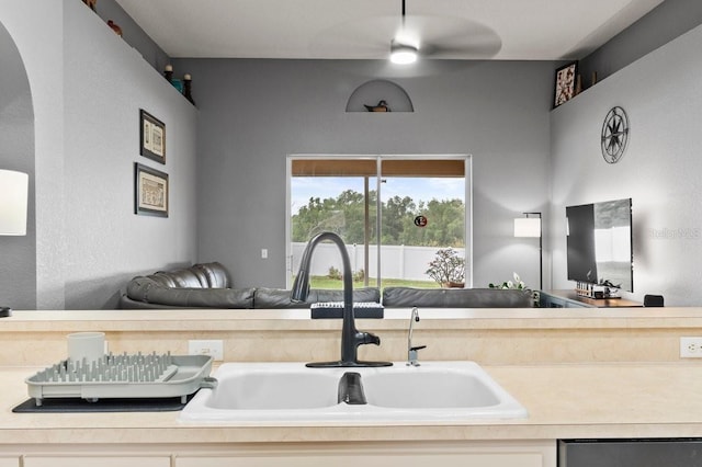 4041 Byrds Crossing Dr, Lakeland, FL 33812 - kitchen with a sink, dishwasher, arched walkways, open floor plan, and light countertops