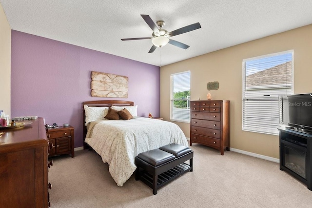 4041 Byrds Crossing Dr, Lakeland, FL 33812 - bedroom featuring light carpet, baseboards, a ceiling fan, and a textured ceiling