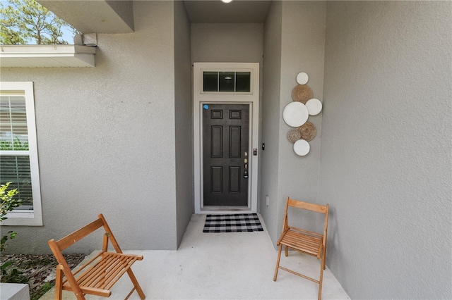 1825 Wallace Manor Ln, Winter Haven, FL 33880 - doorway to property with stucco siding