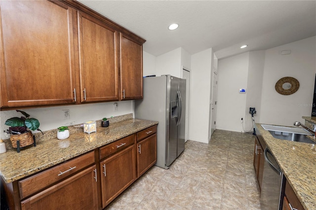 1825 Wallace Manor Ln, Winter Haven, FL 33880 - kitchen featuring dishwashing machine, a sink, light stone countertops, stainless steel fridge, and recessed lighting