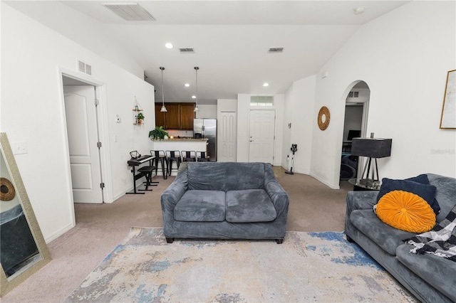 1825 Wallace Manor Ln, Winter Haven, FL 33880 - living room with light carpet, lofted ceiling, arched walkways, baseboards, and recessed lighting