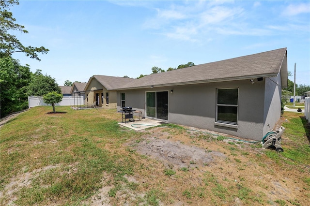 1825 Wallace Manor Ln, Winter Haven, FL 33880 - rear view of property with stucco siding, a patio area, and a shingled roof