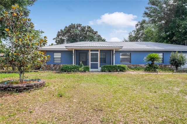 120 Bolender Rd, Auburndale, FL 33823 - view of front of house with stucco siding, a front lawn, metal roof, and a sunroom