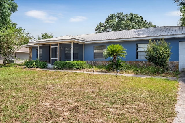 120 Bolender Rd, Auburndale, FL 33823 - view of front of house featuring a sunroom, stucco siding, a front yard, and metal roof