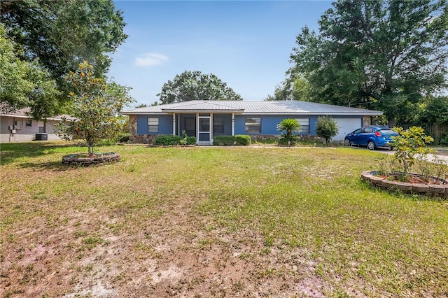 120 Bolender Rd, Auburndale, FL 33823 - view of front of home with a front lawn, metal roof, a sunroom, and an attached garage