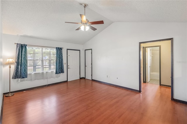 120 Bolender Rd, Auburndale, FL 33823 - unfurnished bedroom featuring lofted ceiling, wood finished floors, a textured ceiling, a ceiling fan, and baseboards