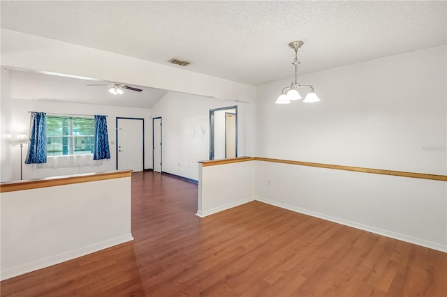 120 Bolender Rd, Auburndale, FL 33823 - spare room with wood finished floors, a chandelier, baseboards, ceiling fan, and a textured ceiling