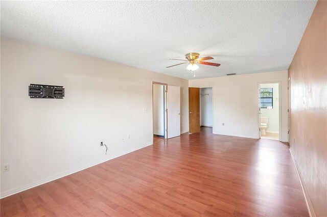 120 Bolender Rd, Auburndale, FL 33823 - empty room featuring wood finished floors, ceiling fan, a textured ceiling, and baseboards