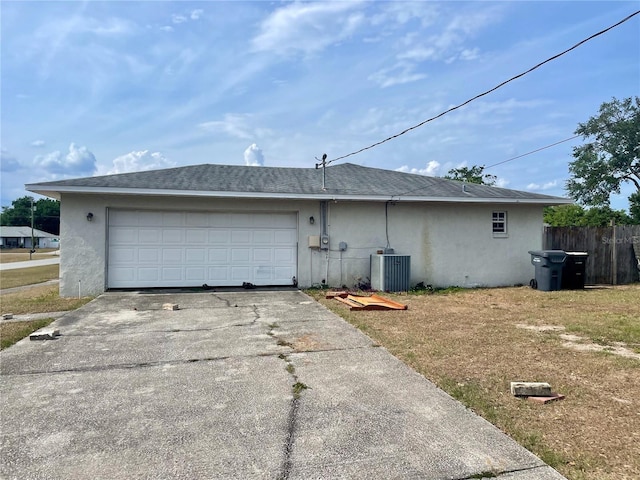 4038 Lehman Ln, Lakeland, FL 33813 - view of property exterior with stucco siding, central air condition unit, asphalt driveway, fence, and an attached garage