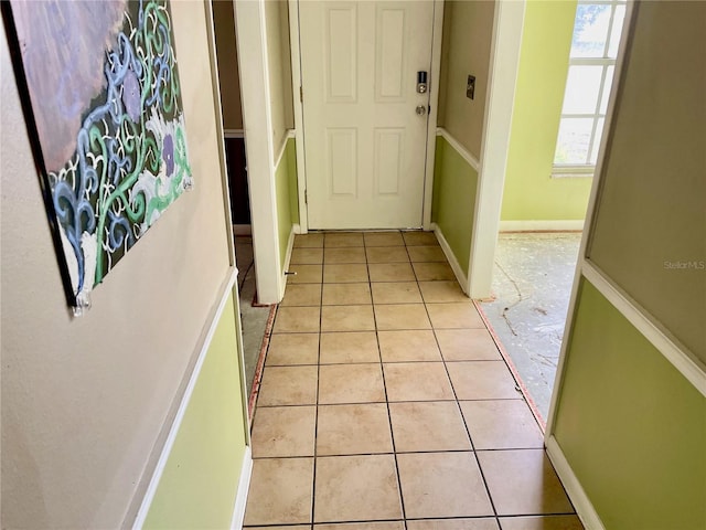 4038 Lehman Ln, Lakeland, FL 33813 - doorway featuring light tile patterned floors and baseboards
