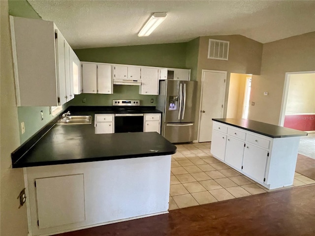 4038 Lehman Ln, Lakeland, FL 33813 - kitchen featuring stainless steel appliances, vaulted ceiling, dark countertops, under cabinet range hood, and light tile patterned floors