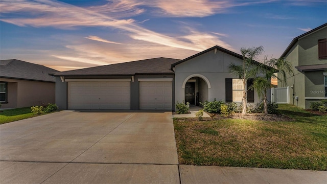 2991 Flying Blackbird Rd, Bartow, FL 33830 - view of front of property featuring driveway, an attached garage, stucco siding, and a front yard