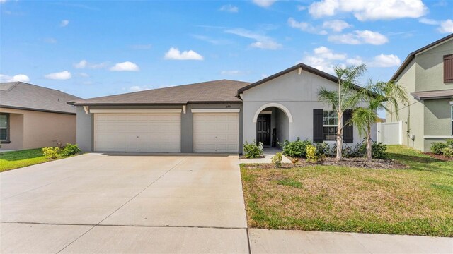 2991 Flying Blackbird Rd, Bartow, FL 33830 - ranch-style house featuring driveway, an attached garage, and stucco siding