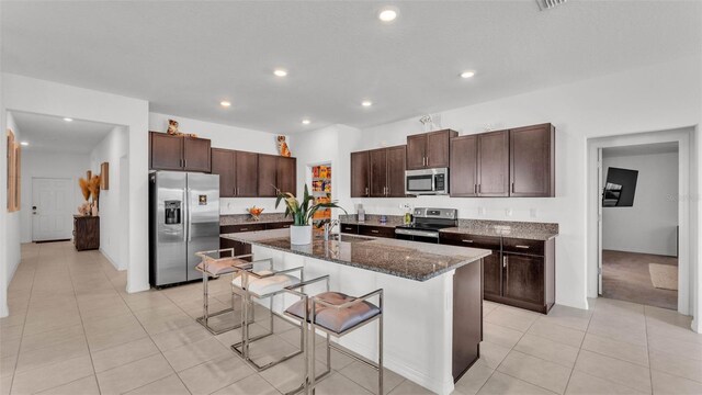 2991 Flying Blackbird Rd, Bartow, FL 33830 - kitchen featuring appliances with stainless steel finishes, a sink, recessed lighting, a kitchen bar, and dark brown cabinetry