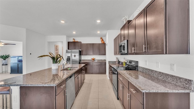 2991 Flying Blackbird Rd, Bartow, FL 33830 - kitchen featuring stainless steel appliances, a sink, dark brown cabinets, light tile patterned floors, and recessed lighting