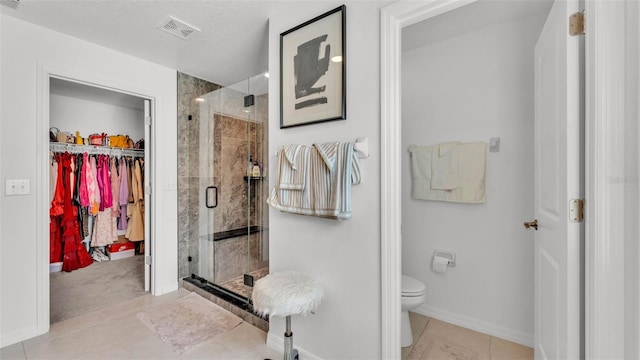 2991 Flying Blackbird Rd, Bartow, FL 33830 - full bathroom with a stall shower, a spacious closet, toilet, tile patterned floors, and baseboards