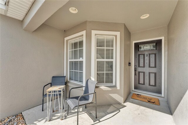 property entrance with stucco siding