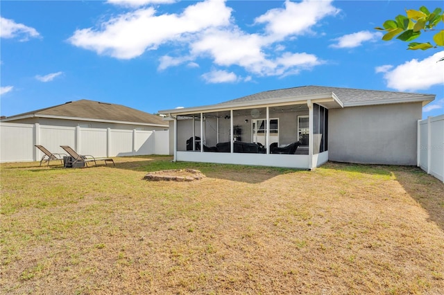 rear view of house featuring a sunroom