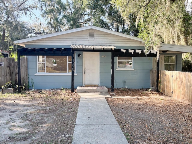 bungalow-style home featuring fence
